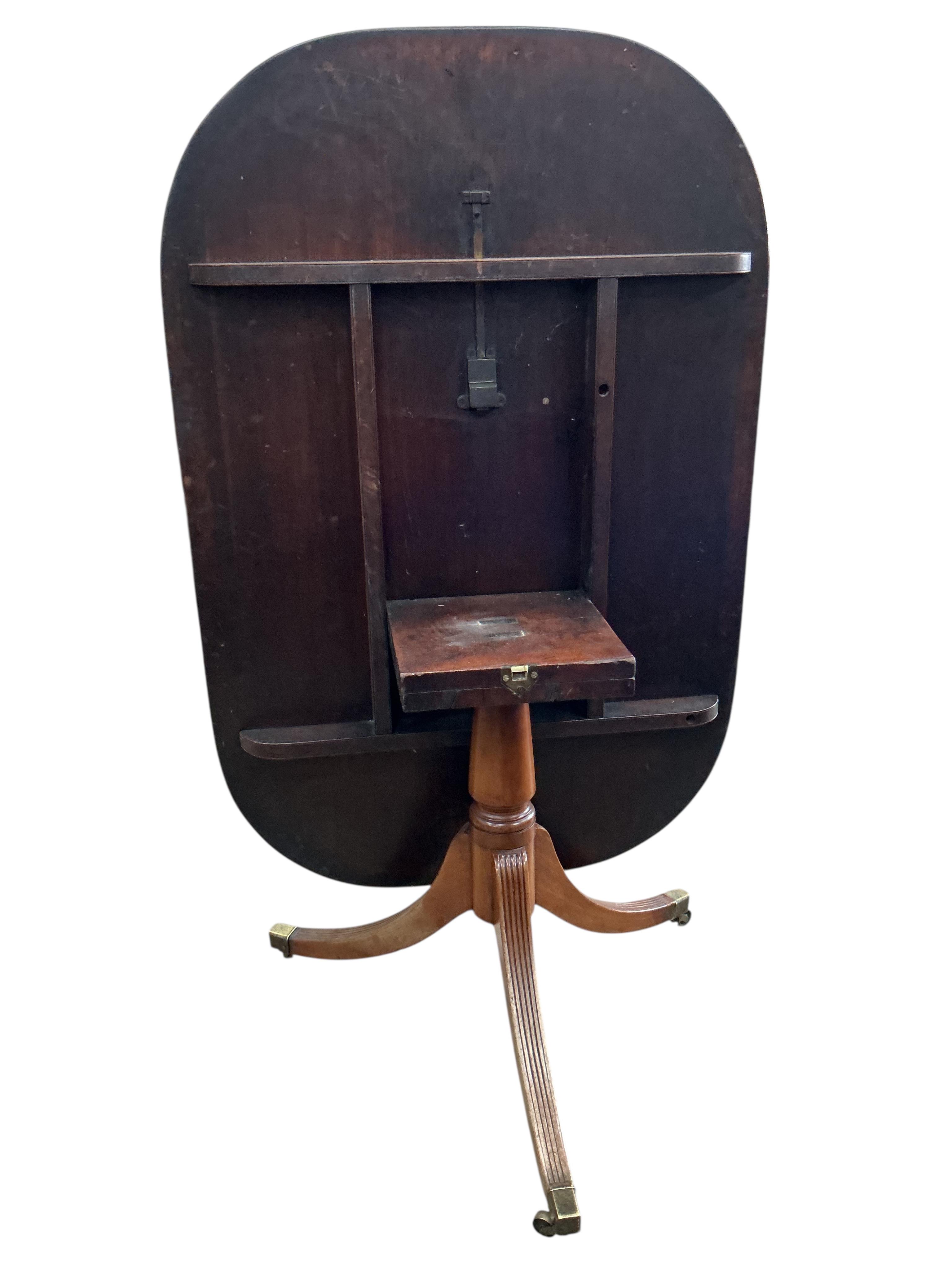 A George III mahogany rectangular tilt top dining table, width 126cm, depth 84cm, height 69cm